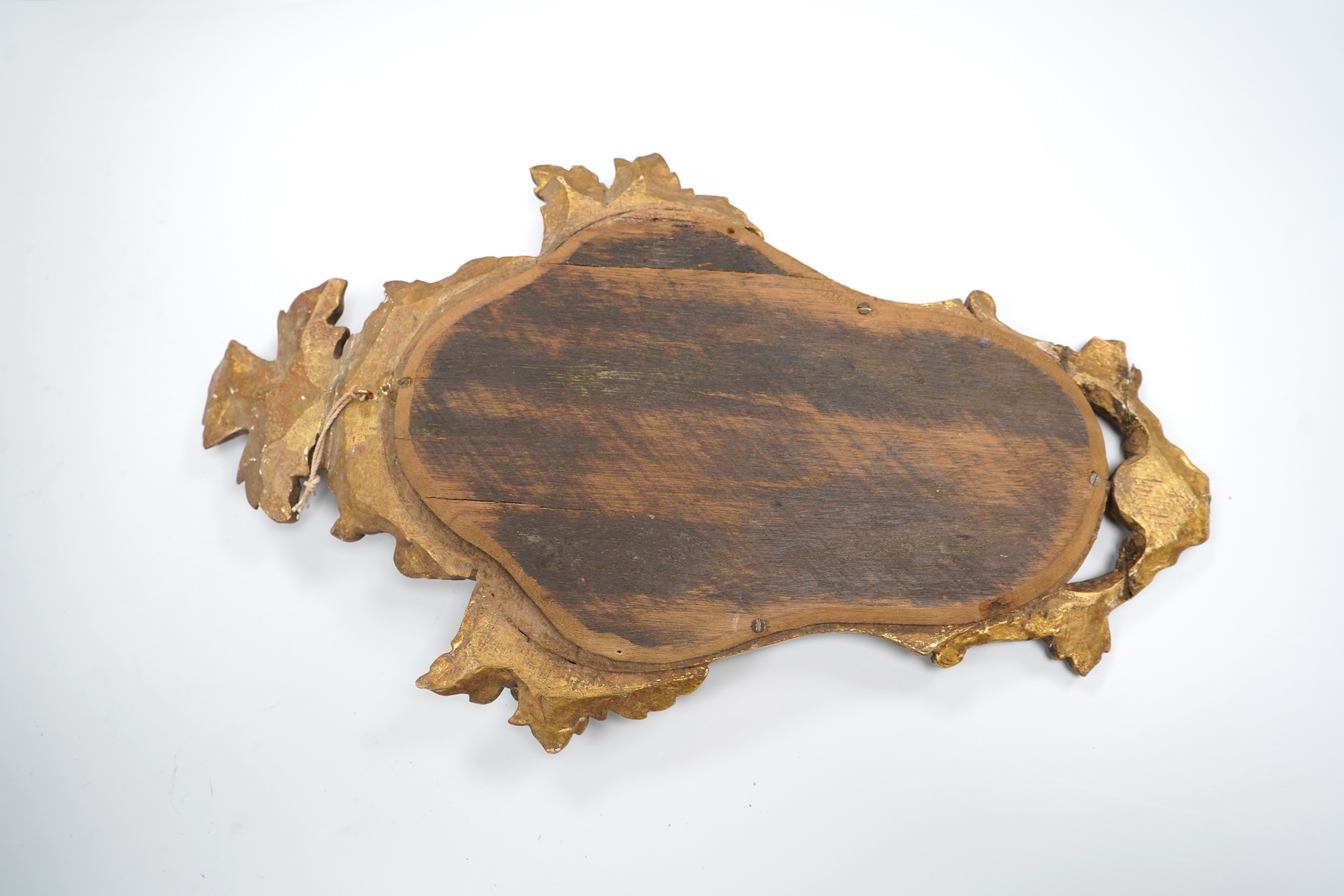 A small 19th century Italian carved giltwood mirror, 43cm high